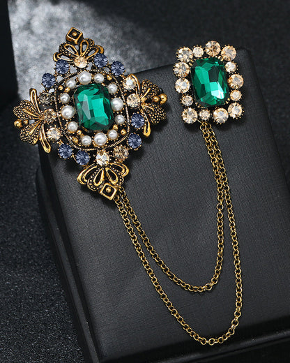 Baroque British style brooch with emerald pins