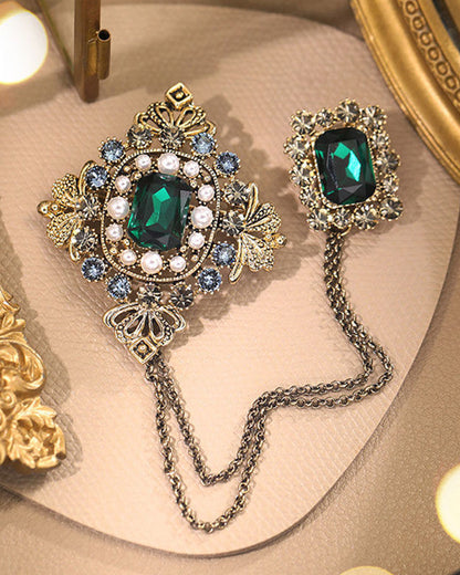 Baroque British style brooch with emerald pins