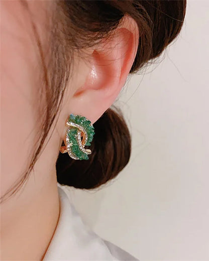 Fashionable cross earrings with green crystals